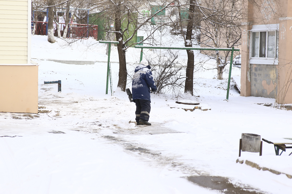 На дорогах и в жилых кварталах Находки убирают первый снег нового года